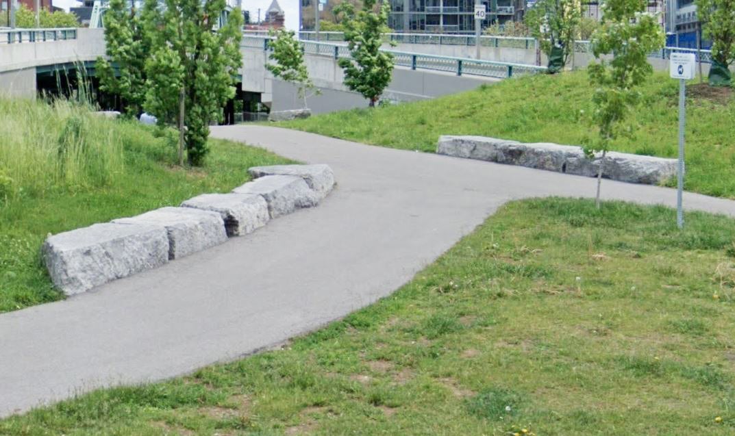 a section of a city street where new boulders have been installed