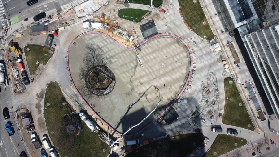 Aerial of a heart-shaped pond under construction in a park. 
