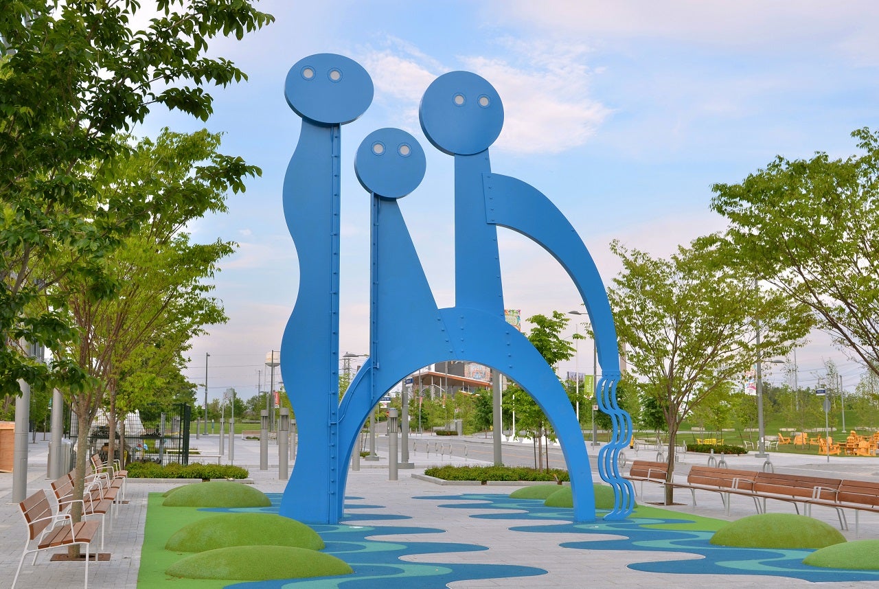 Three curvy blue public art structures that are also water features.