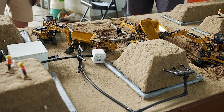 close-up of a science experiment out of sand and toy construction equipment