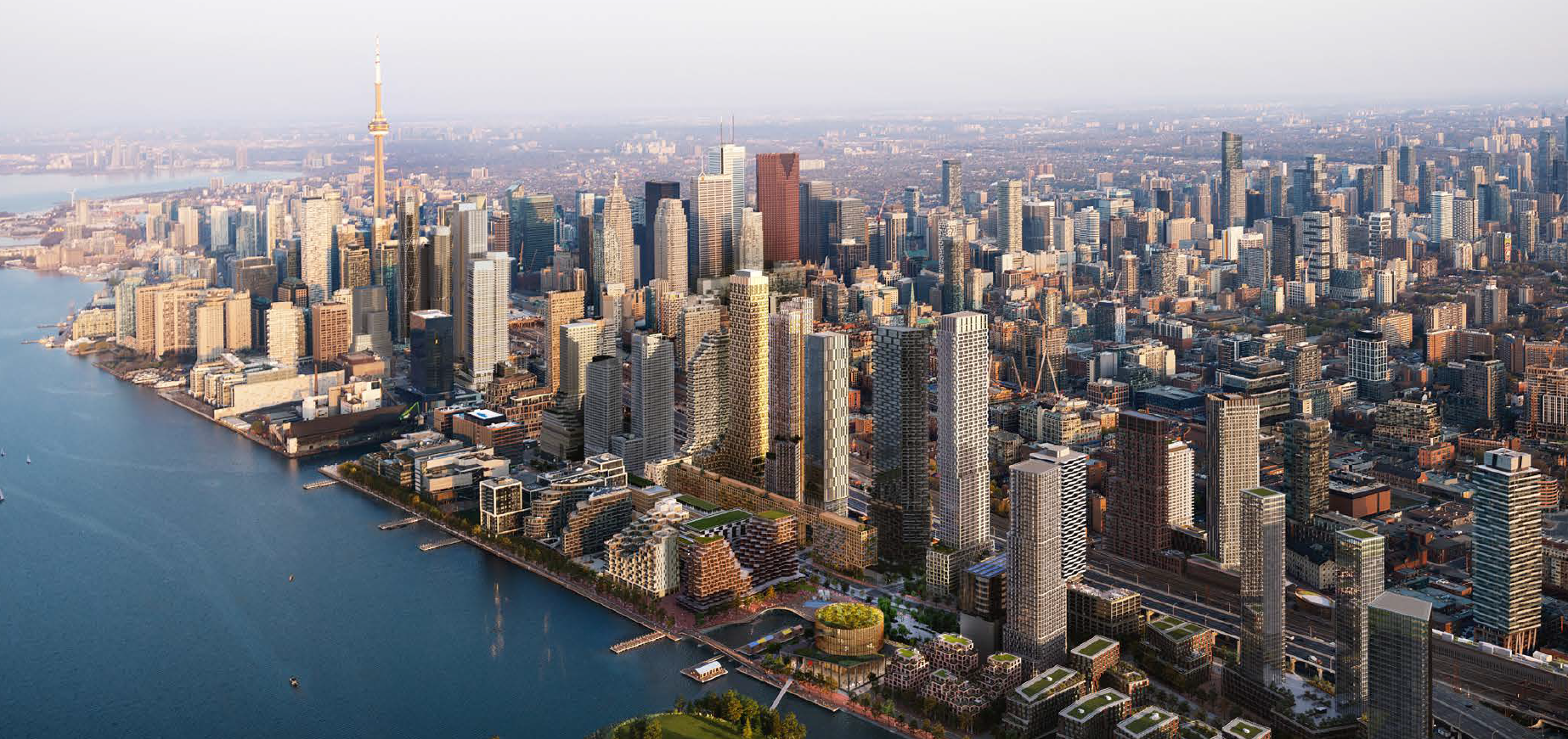 The skyline of Toronto, with Lake Ontario in the foreground and dense downtown buildings beyond.