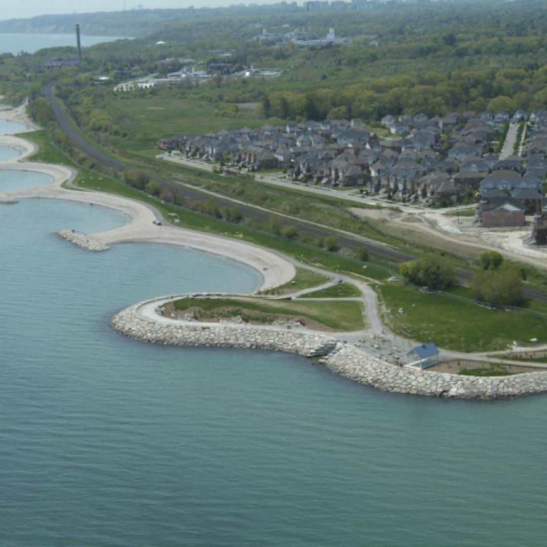 an aerial view of a linear park and shoreline