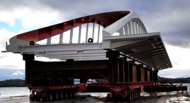 a white and red bridge on a barge