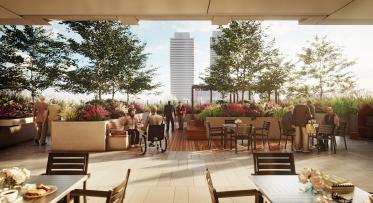 Artist's rendering of future long term health care facility in West Don Lands. A rooftop surrounded by greenery and flowers with skyline in the background as elderly people soak in the sunlight. 